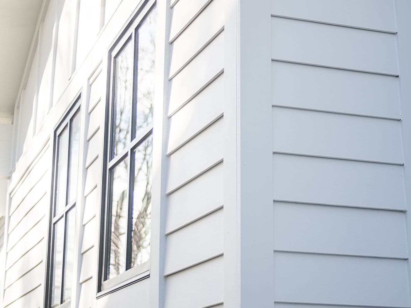 Classic white home with LP SmartSide lap siding and black shutters.