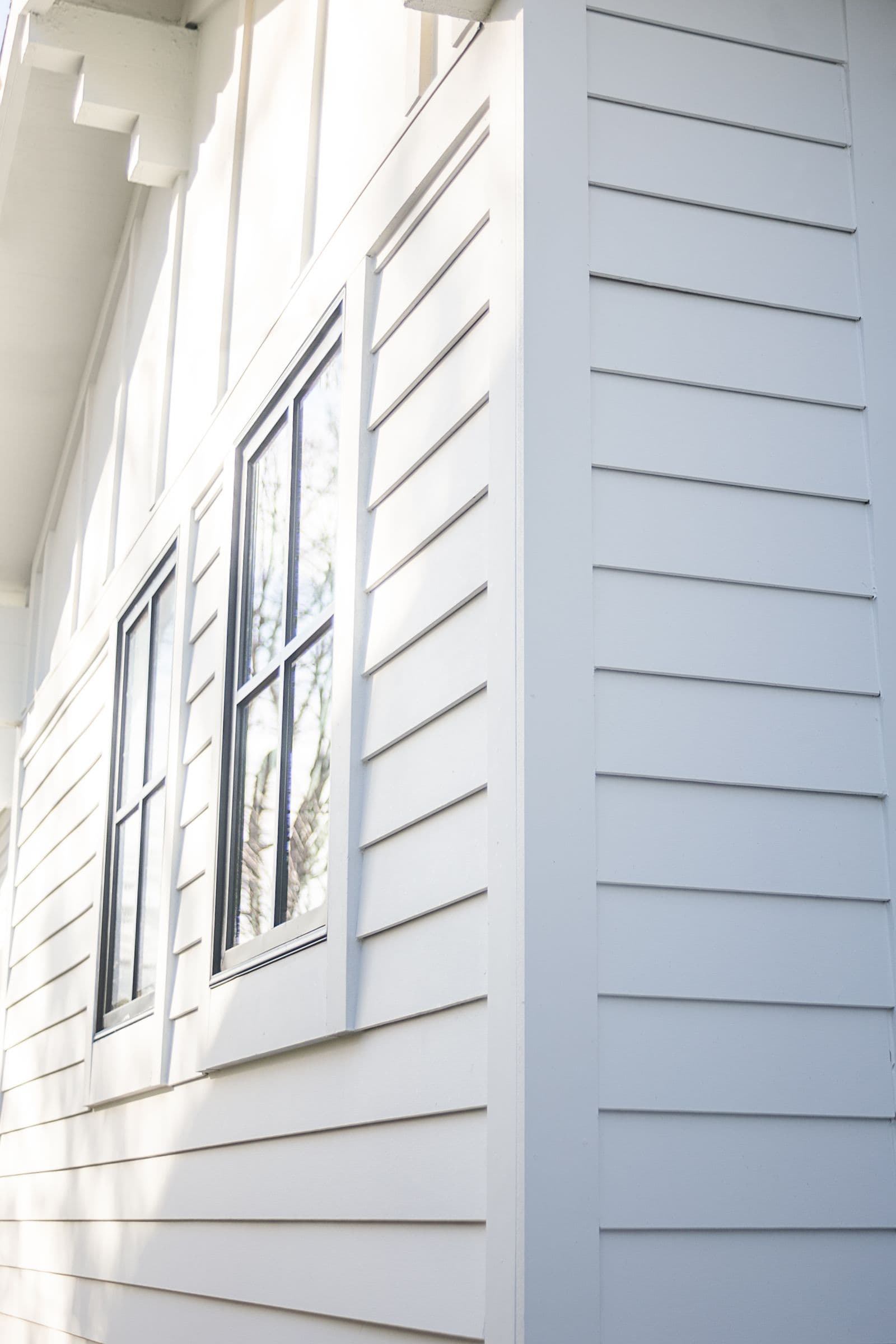 Classic white home with LP SmartSide lap siding and black shutters.