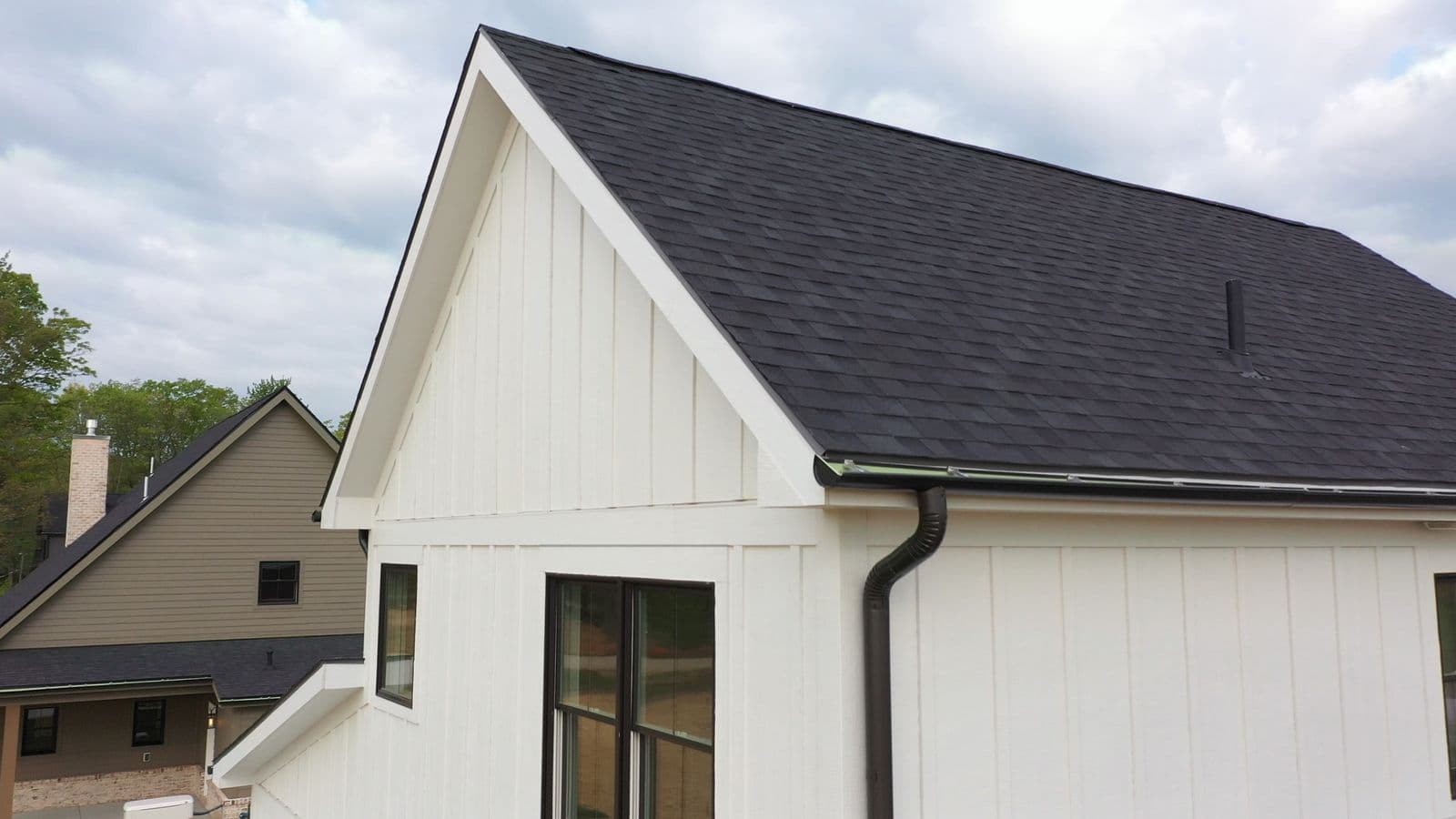 White farmhouse-style gable with LP SmartTrim fascia and rake trim.